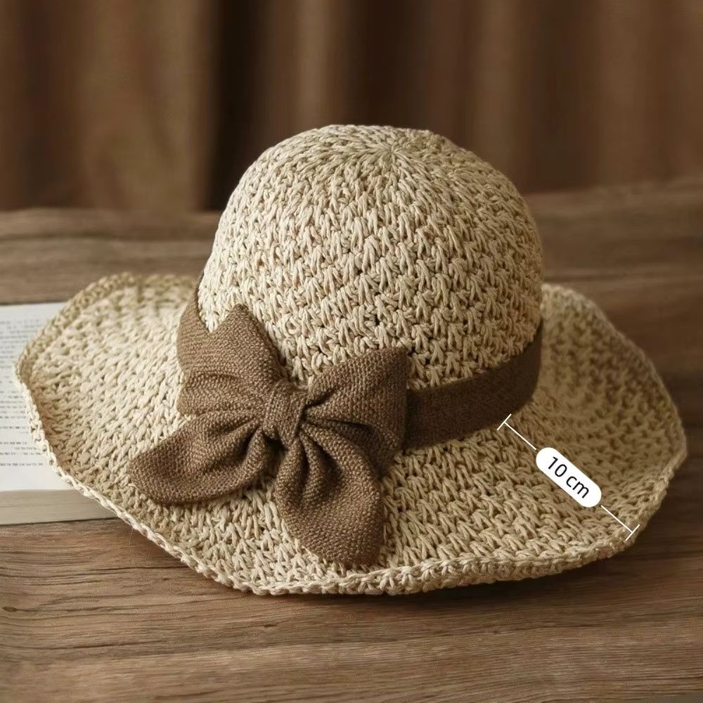 Packable straw sun hat for women in beige, front view