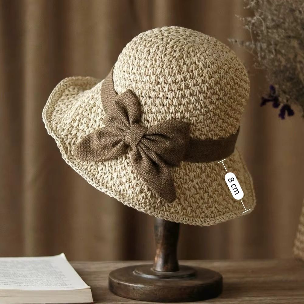 Wide-brim straw beach hat with bow, styled